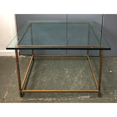 864 - A contemporary coffee of side table, the heavy glass top on a base of square section brass, approx. ... 