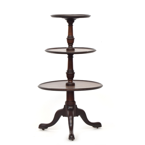 521 - A George III mahogany three-tier dumb-waiter, the three graduating dish tops on a turned column supp... 