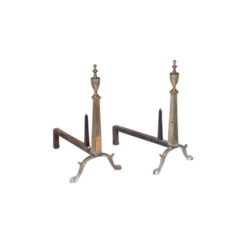 428 - A pair of pressed andirons in George III style, with urn finials above the tapering stems and bipeda... 