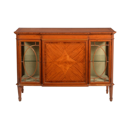 517 - An Edwardian satinwood breakfront display cabinet, the glazed doors enclosing glass shelves, a print... 