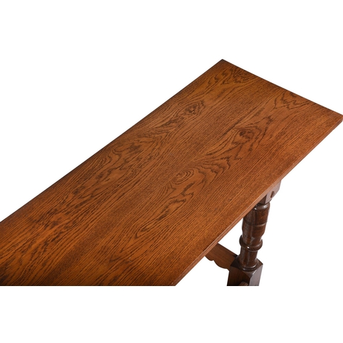 466 - An oak serving table in late 17th century style, on turned supports and shaped peripheral stretchers... 