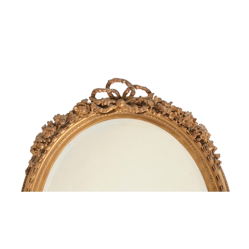 385 - A Victorian giltwood and composition wall mirror, c.1870, with tied ribbon and floral swag cresting,... 