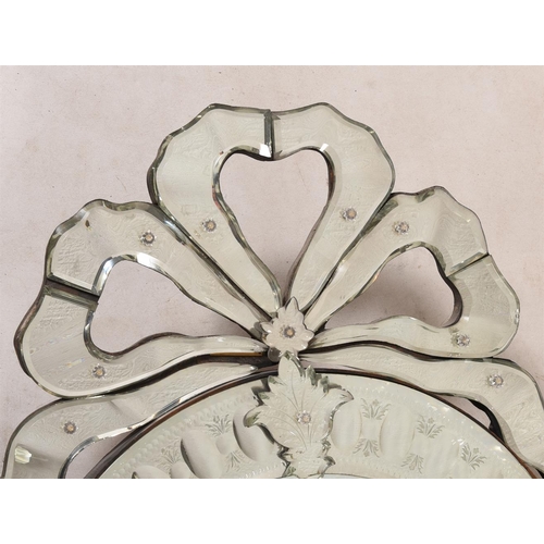 394 - A wall mirror in Venetian taste, 68cm wide, 110cm high