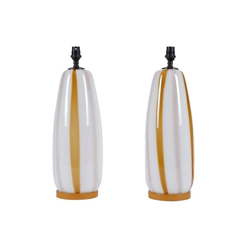 382 - A pair of opaque and amber glass table lamps, with paper 'Gingham' shades, 64cm high overall