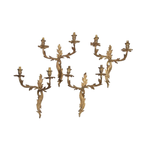 379 - A set of four early 20th century gilt metal twin arm wall appliques in Louis XV style, 33cm wide, 16... 