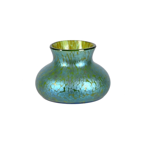 212 - An Art Nouveau iridescent green glass vase of compressed form and of Loetz type, 9cm high