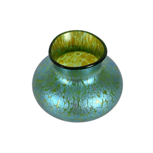 212 - An Art Nouveau iridescent green glass vase of compressed form and of Loetz type, 9cm high