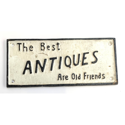 150 - A cast iron sign 'The Best Antiques Are Old Friends', 10.5x23.5cm