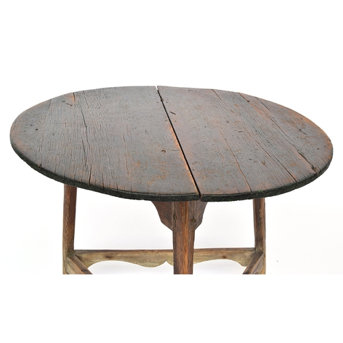 469 - A 19th century pine cricket table, circular two plank top with traces of original painted finish, on... 