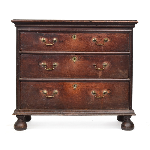 474 - An early 18th century and later oak chest of drawers, the top with heavy moulding, over three gradua... 