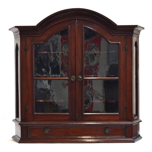 519 - A domed mahogany glazed china cabinet, the doors opening to reveal three shelves, with drawer below,... 