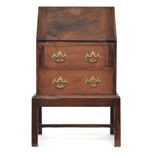 477 - An 18th century and later bureau, the fall front opening to a fitted interior, over two drawers, rai... 