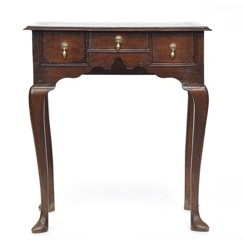 553 - A George I/II oak lowboy, moulded top over three drawers, raised on cabriole legs and pad feet, 69cm... 