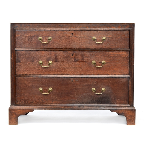 475 - An 18th century oak chest of three graduating drawers, the drawers surrounded by carcass mounted dou... 