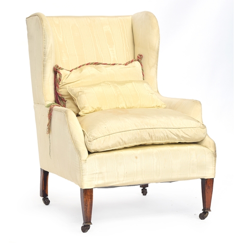 605 - A good wingback armchair, upholstered in watered silk, on square tapered legs with brass caps and ca... 