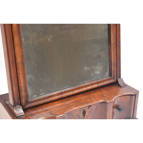 400 - An 18th century walnut box mirror, the original plate within a moulded frame, over a single shaped d... 