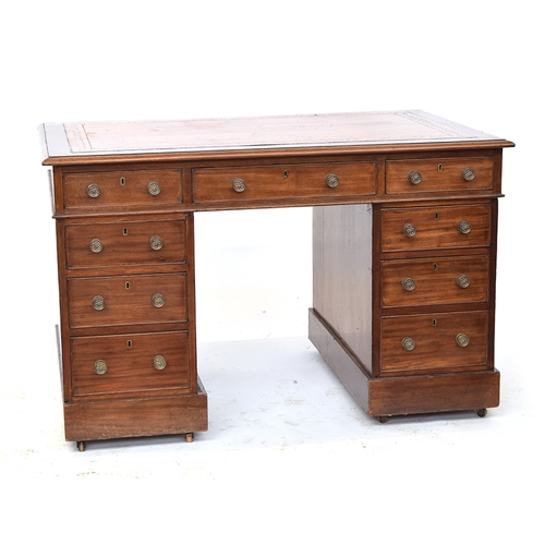 575 - A Victorian mahogany pedestal desk, with tooled leather skiver, the kneehole with the traditional ar... 