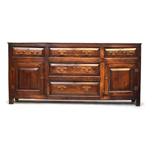 507 - An 18th century and later sideboard or dresser base, comprising an arrangement of drawers and cupboa... 