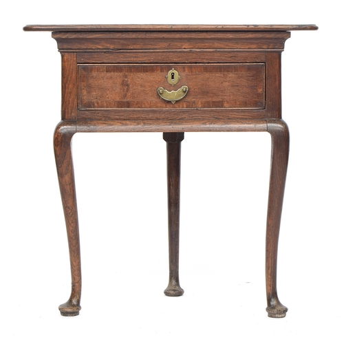 551 - A George II triangular oak and crossbanded corner table, single frieze drawer, on three cabriole leg... 