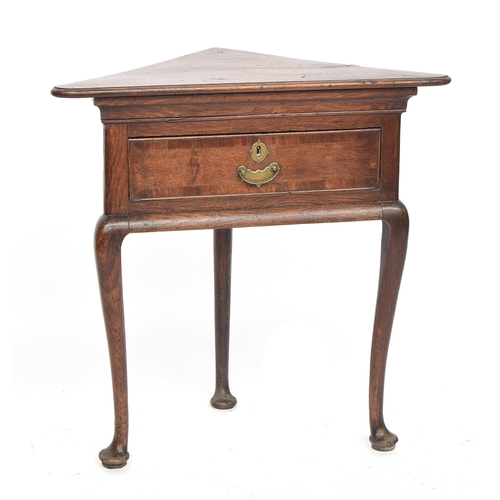 551 - A George II triangular oak and crossbanded corner table, single frieze drawer, on three cabriole leg... 