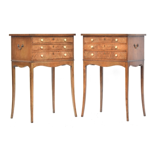 635 - A pair of mahogany cabinets, each with three drawers, with brass carry handles, raised on slender sw... 