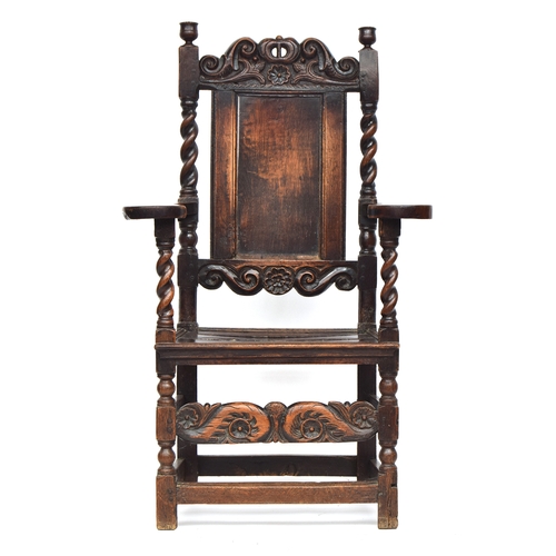 458 - A Charles II oak armchair, c.1670, of unusual form, the rectangular panelled back surmounted by a ca... 