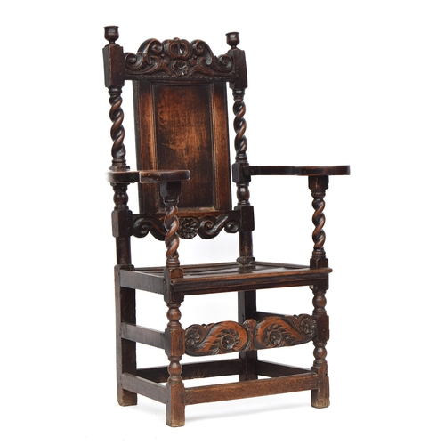 458 - A Charles II oak armchair, c.1670, of unusual form, the rectangular panelled back surmounted by a ca... 