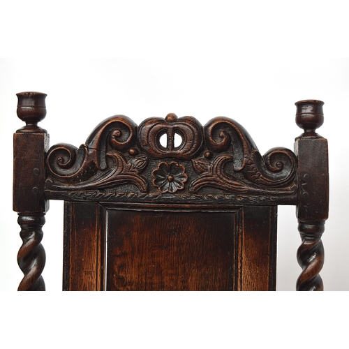 458 - A Charles II oak armchair, c.1670, of unusual form, the rectangular panelled back surmounted by a ca... 