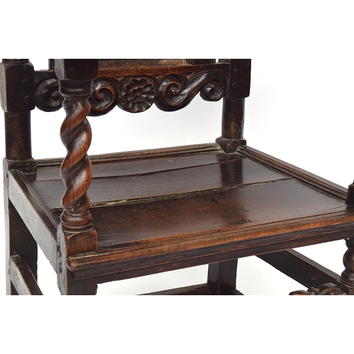 458 - A Charles II oak armchair, c.1670, of unusual form, the rectangular panelled back surmounted by a ca... 