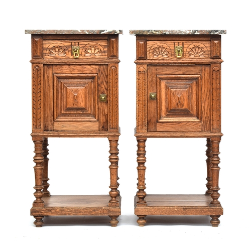 637 - A pair of marble topped oak night stands, each with single demilune carved drawer over a panelled cu... 