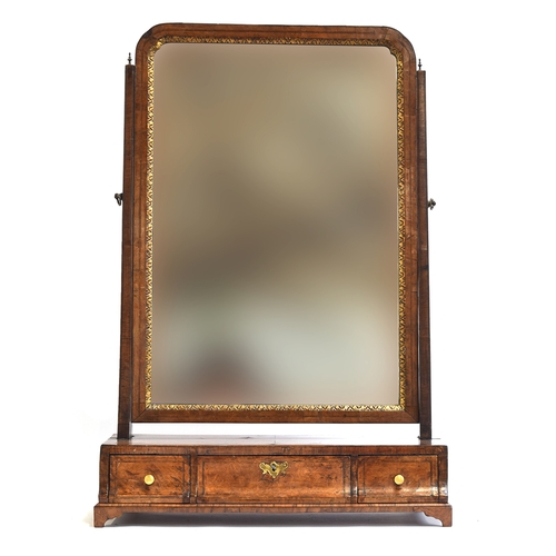 399 - A George II walnut dressing mirror, the plate within a gilt slip, over a base of three drawers on br... 