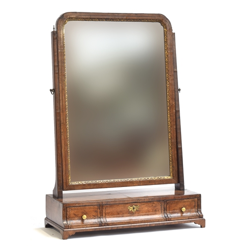 399 - A George II walnut dressing mirror, the plate within a gilt slip, over a base of three drawers on br... 