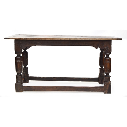 463 - A 17th century and later oak refectory table, the cleated planked top on block turned cup and cover ... 