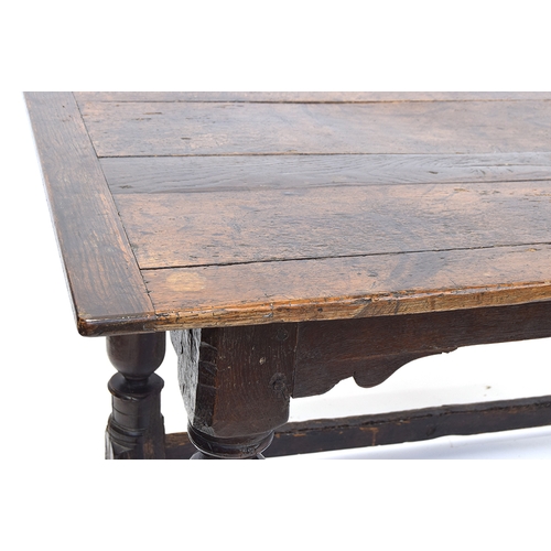 463 - A 17th century and later oak refectory table, the cleated planked top on block turned cup and cover ... 