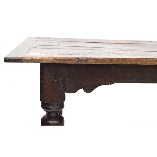 463 - A 17th century and later oak refectory table, the cleated planked top on block turned cup and cover ... 