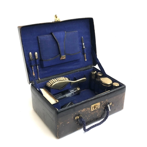 165 - A leather gent's vanity case, the fitted interior containing various pots, brushes, and tweezers, th... 