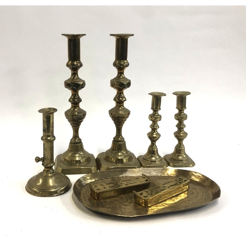 180 - An 18th century and later brass ejector candlestick, 16.5cmH; together with two further pairs of can... 