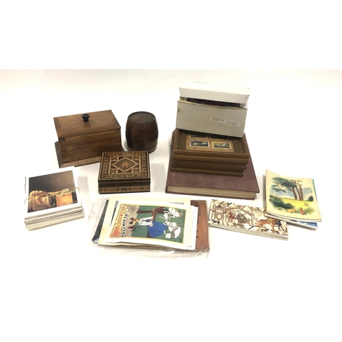 185 - A mixed lot to include several wooden boxes including a treen barrel, a small collection of postcard... 