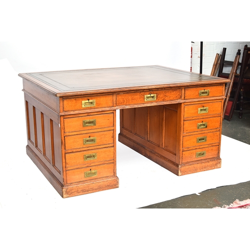 577 - An oak partner's desk, gilt tooled leather skiver, one side with the traditional arrangement of nine... 