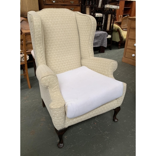 657 - A 20th century wingback armchair on cabriole legs, 85cmW