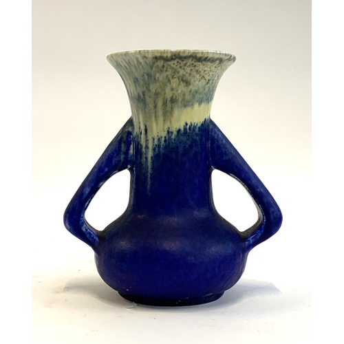 58 - An Arts and Crafts twin handled Ruskin pottery vase glazed in blue with yellow and blue mottled glaz... 