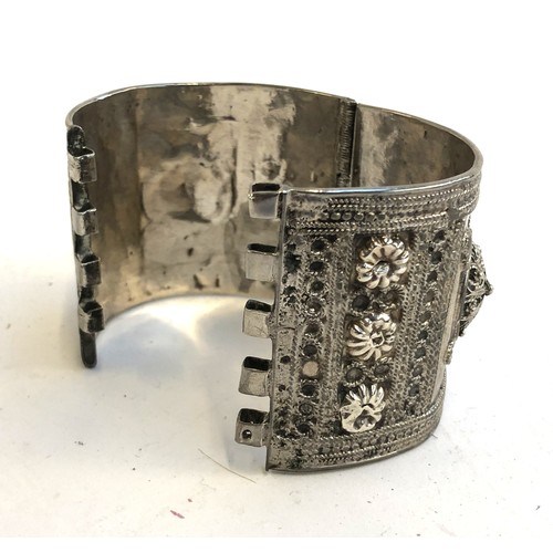 7 - An Eastern white metal bangle, approx. 111g