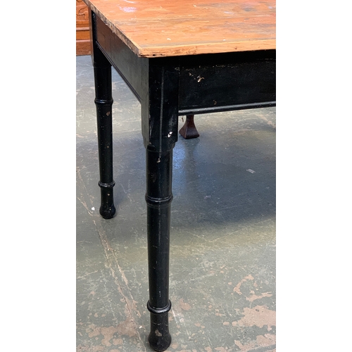 582 - A vintage pine kitchen table, on a black painted base with ring turned legs, 120x74x75cmH