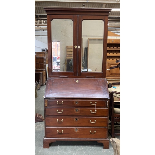 702 - A George III bureau bookcase, c.1760, the mirrored doors opening to an interior of adjustable shelve... 