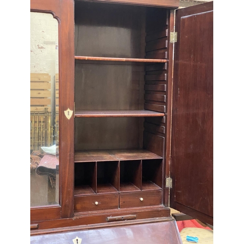 702 - A George III bureau bookcase, c.1760, the mirrored doors opening to an interior of adjustable shelve... 