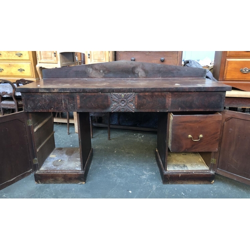 594 - A large Victorian mahogany pedestal sideboard, three drawers, the central drawer with carved decorat... 