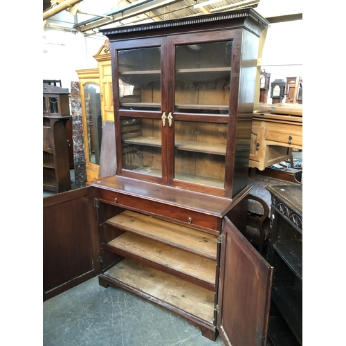 599 - A George III mahogany library bookcase, dentil cornice over two glazed doors, opening to three adjus... 