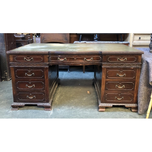 652 - A large mahogany partners desk, green leather skiver, the top with three drawers to each end, the pe... 