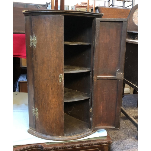 653 - A George III oak bowfront corner cupboard, 55cmW