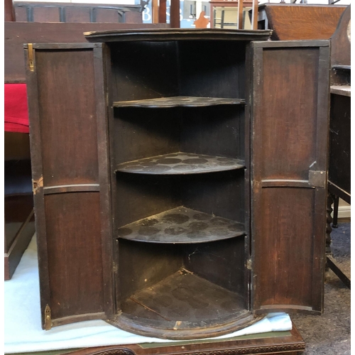 653 - A George III oak bowfront corner cupboard, 55cmW